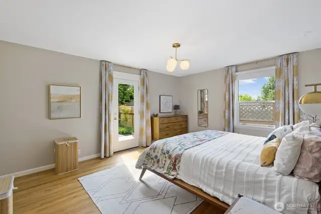 Oversized primary bedroom on the main floor with walk out to backyard deck.