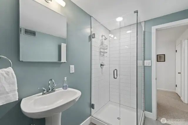 Beautifully remodeled downstairs bathroom to serve two lower level bedrooms and rec room.