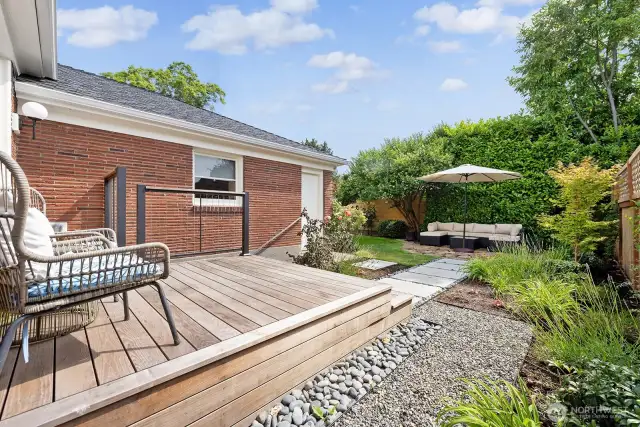Private, quiet backyard retreat with professional landscaped paths, deck and patio. Door to garage for lawn care equipment storage.