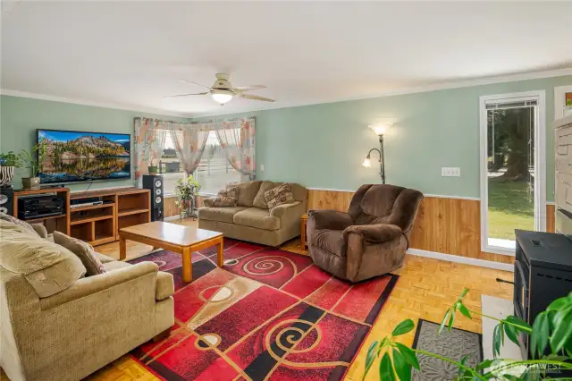 Living area has parquet flooring & wainscotting.