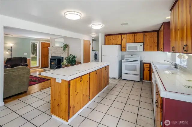 Large kitchen with tile floors & counters.