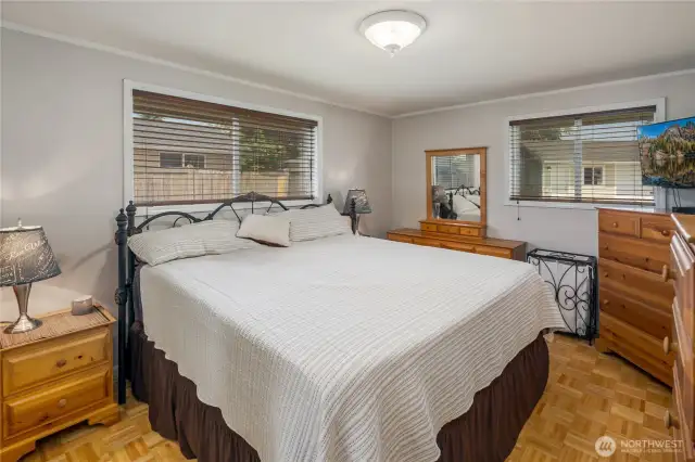 Primary bedroom has 2 closets & parquet flooring.