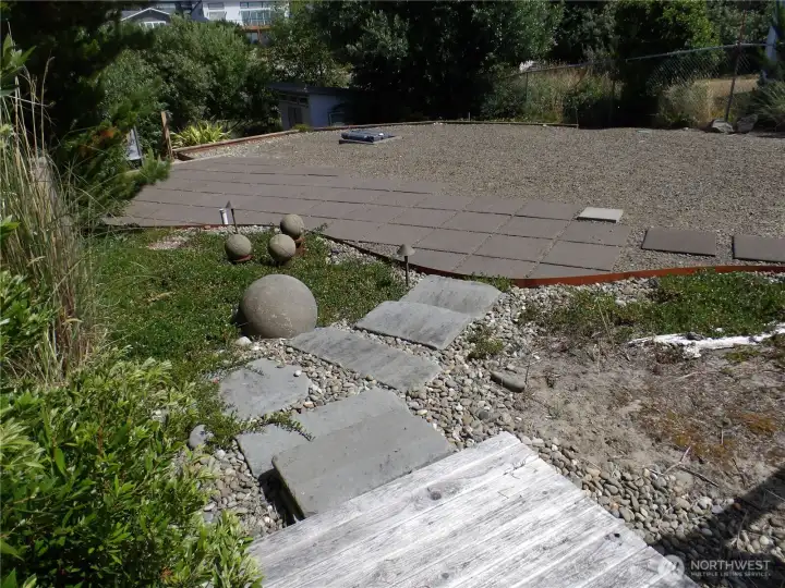 Nice perspective of the lot.  Here you see the small raised deck and North side of the lot where RV can go.