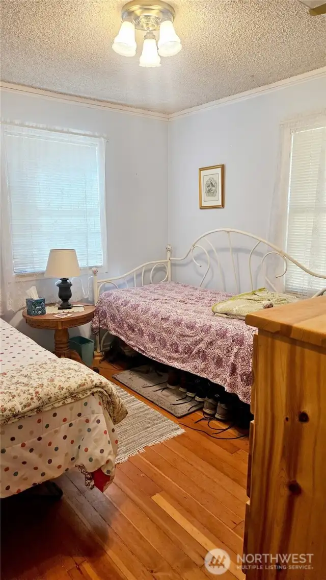 Bedroom with original hardwood floors.