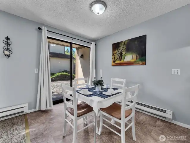 Dining room with new LED light, easy-care vinyl flooring, and access to the patio perfect for indoor/outdoor living.