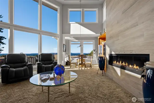 Modern coastal living with floor-to-ceiling windows and a gas fireplace that keeps you cozy in cooler months