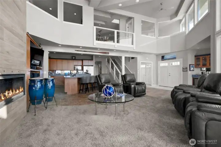 By design the home strategically placed interior windows on the upper floor bedrooms- providing more possibilities for views.  Kitchen is tucked in underneath and the entrance to the primary suite beyond the stairs