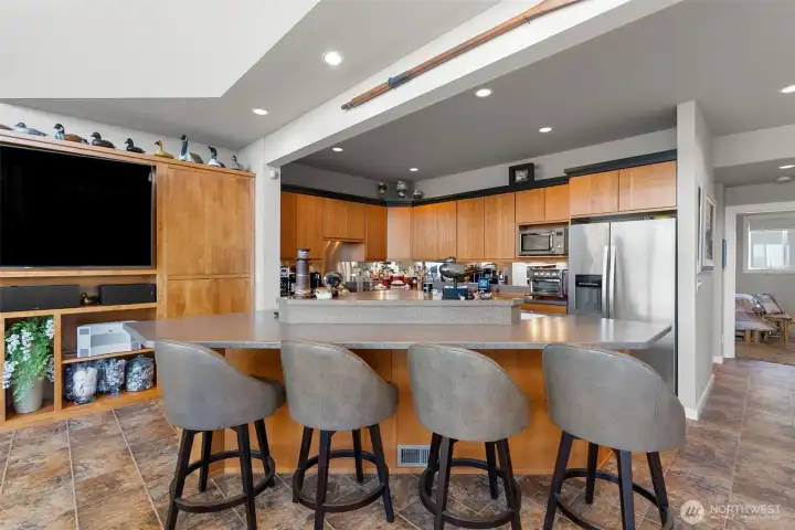 Eat casual at the island bar- watch the game or support the cook- there is plenty of room.  Down the hall is the primary bedroom and access to the garage through the mudroom/laundry area