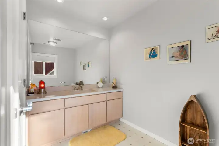 Second bedroom ensuite bathroom- cohesively built with the same cabinetry of the other bathrooms