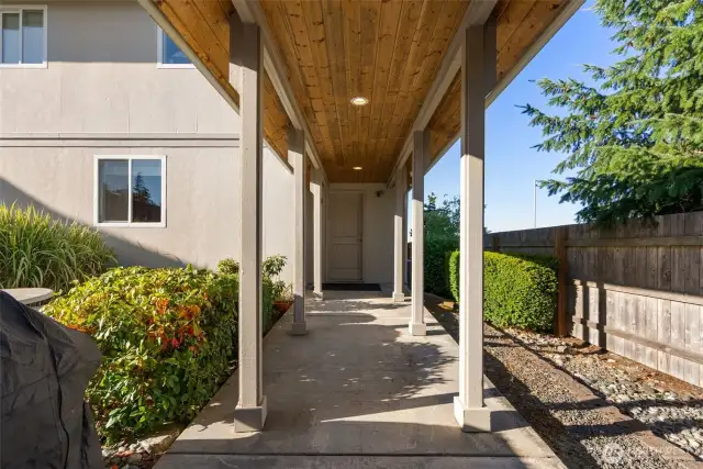 Side door from the utility room takes you under the breezeway that connects to the detached garage