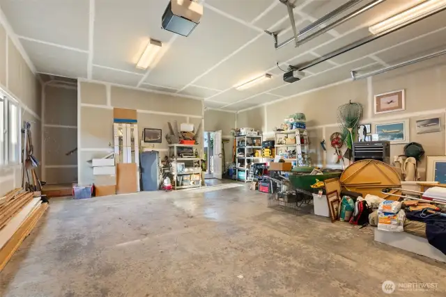 Spacious 2 car garage.  Note the hint of a staircase- an upper unfinished area ready for your ideas.