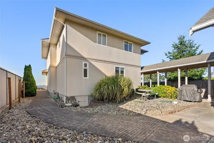Walkway to the front door.  On the right, the breezeway to the garage