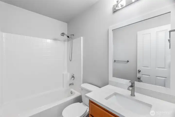Shared bath with updated quartz counters, fixtures and sink