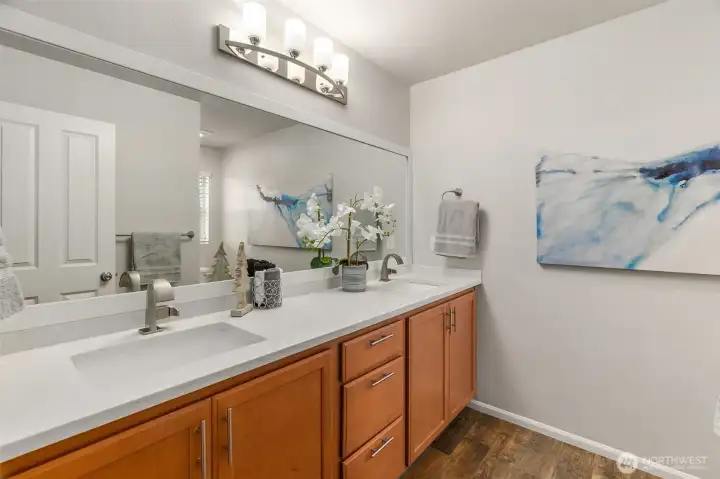 Ensuite five piece primary bath with updated quartz counters, undermount sinks, hardware