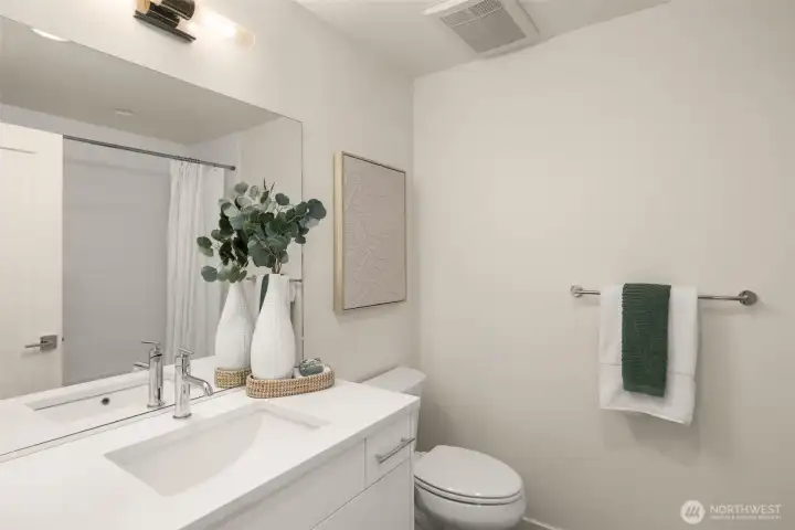 Modern and sleek, this bathroom combines style with functionality. The clean design, complemented by elegant lighting and a spacious vanity, makes it ideal for morning routines and evening relaxation. Photos of home with similar layout, finishes & fixtures.