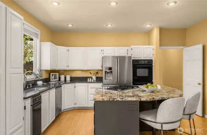 This home is move-in ready  Generous central island, double wall oven and new cooktop makes mealtime carefree and wonderful for entertaining