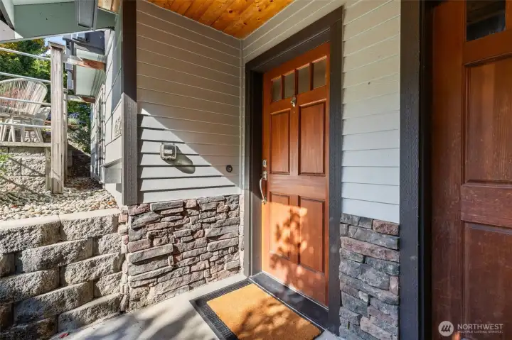 Welcoming front entry with charming stone accents