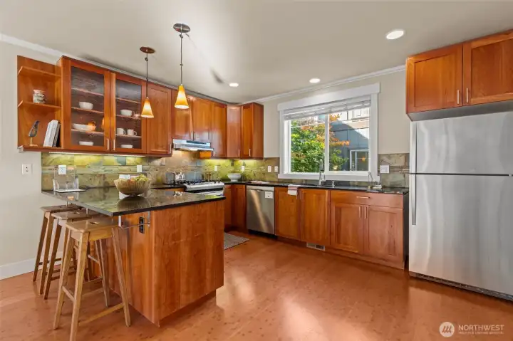 Spacious kitchen with cherry cabinets and granite counters