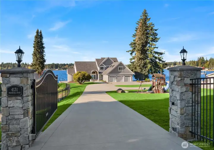 This extraordinary fully fenced and gated estate showcasing 200 feet of rare west-facing shoreline.