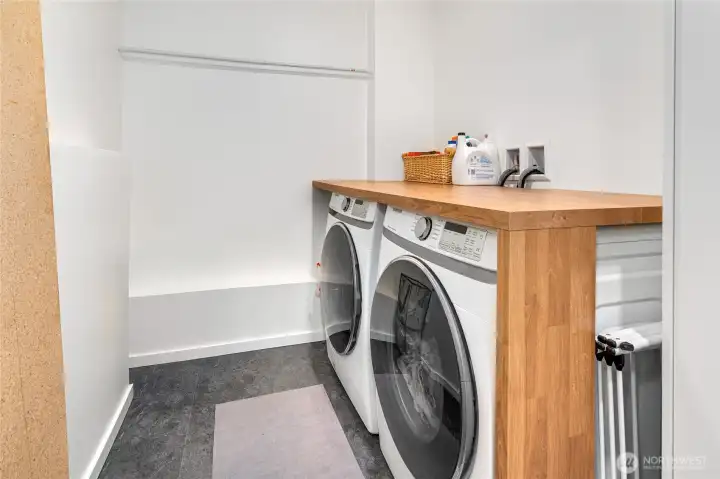 Laundry room downstairs with storage room.