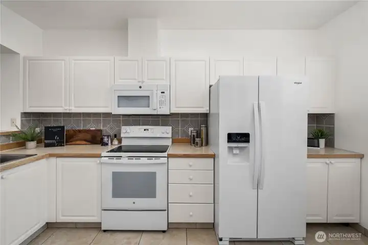 Kitchen has a computer desk to the right and a beautiful storage cabinet out of view.