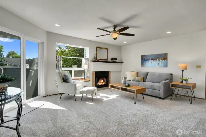 Relax in the living room where you have a slider door that steps out to the balcony, an additional large picture window that overlooks the grounds and a warm wood burning fireplace that brings warmth and ambiance to the room. Relax in the living room where you have a slider door that steps out to the balcony, an additional large picture window that overlooks the grounds and a warm wood burning fireplace that brings warmth and ambiance to the room.