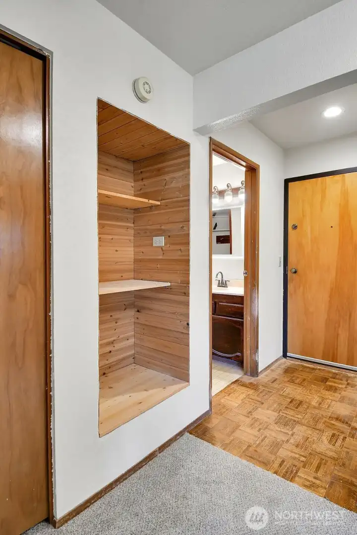 Open built-in shelving just off the entrance has intentional design and function in mind.