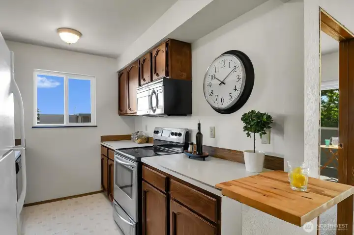 Galley style kitchen has lots of natural light and ample workspace. Galley style kitchen has lots of natural light and ample workspace.