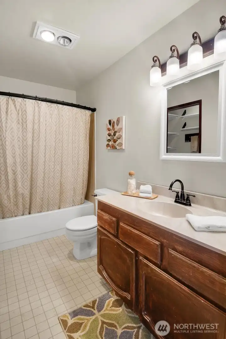 Well-lit full bath has a large vanity with drawers and cabinets for personal storage space. Well-lit full bath has a large vanity with drawers and cabinets for personal storage space.