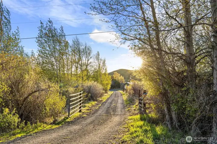 Gated entrance, gravel driveway