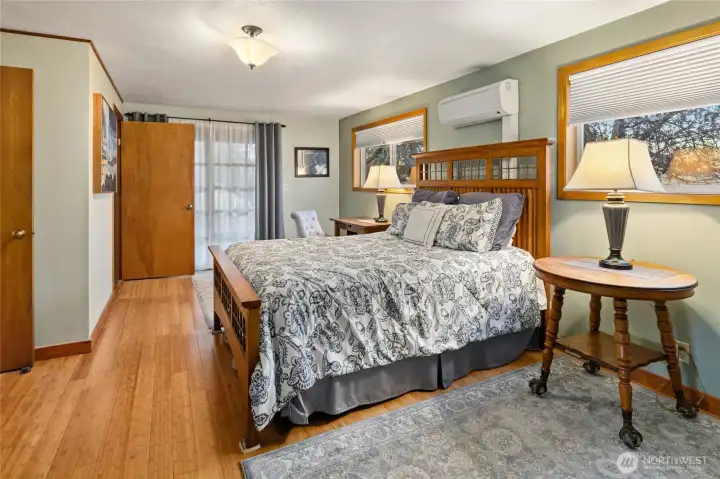 Primary bedroom with bamboo flooring and French doors