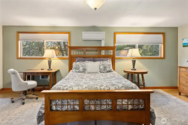 Primary bedroom with French doors to the front deck and a 3/4 en-suite