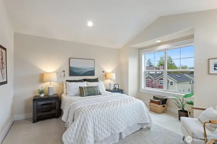 The top floor features a serene primary suite with vaulted ceilings and Mt Rainier & park-facing views, creating a true retreat.