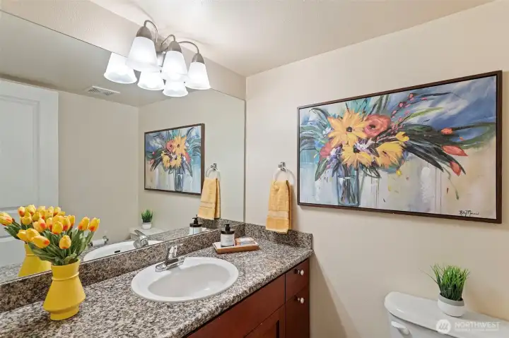 On the entry level, a 2nd powder room with granite counter and tiled flooring.