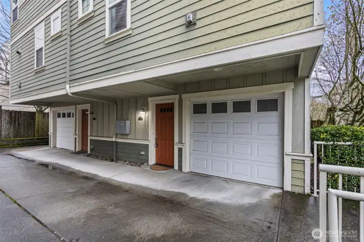 One car garage with window, housing the Rheem 50 Gallon hot water tank and shelving.