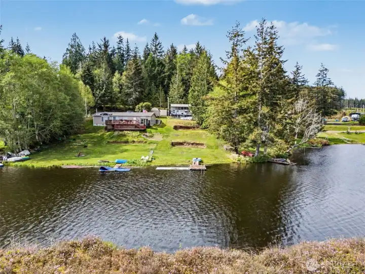 Waterfront perspective showcasing grassy yard and lake access