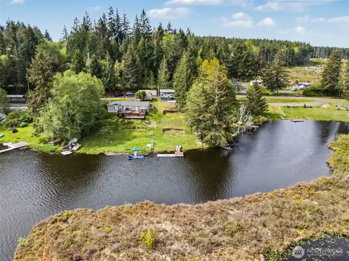 Aerial waterfront view capturing shoreline, dock access, and property positioning