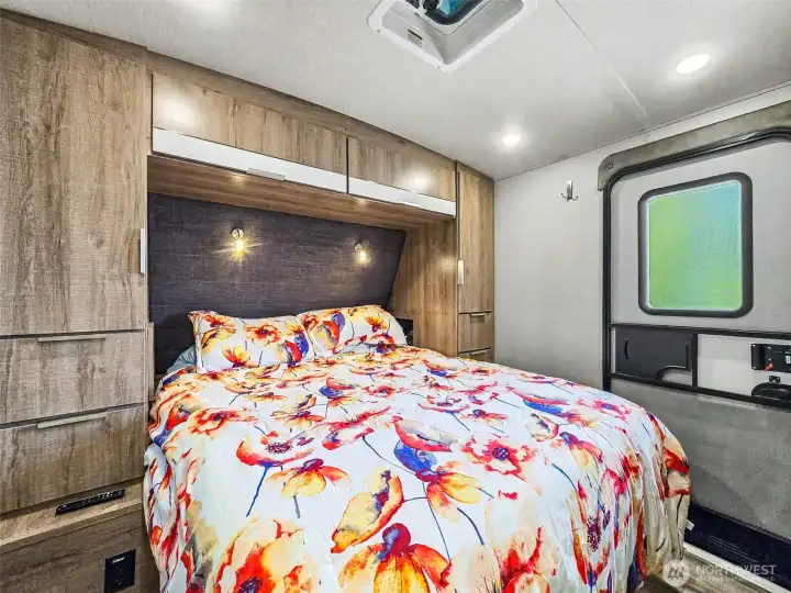 Private bedroom with built-in storage and overhead lighting