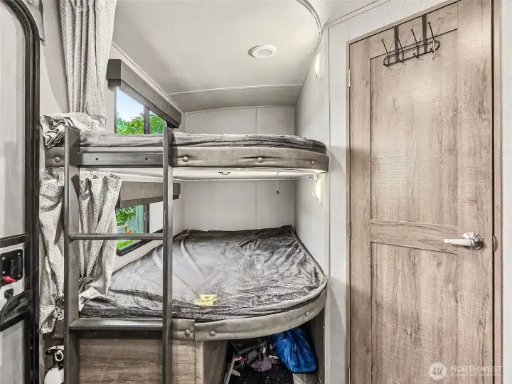 Bunk room detail with window light and under-bed storage