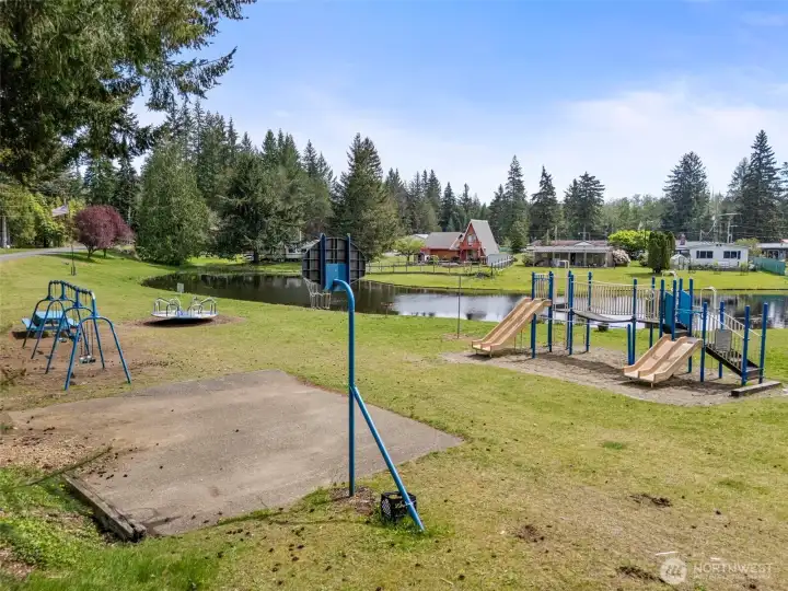 Community playground with open green space and waterfront setting—perfect for outdoor enjoyment