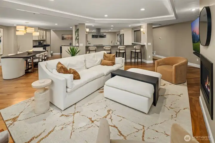 The open floor plan reveals itself fully from this angle — a generous living space flows seamlessly to the dining area and kitchen beyond. Whether hosting a dinner party or a lazy Sunday morning, every zone connects naturally, beautifully, and without effort.