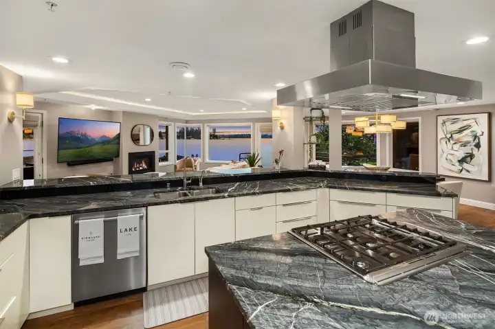 A professional range anchored beneath a stainless hood and a sprawling prep island make this as functional as it is stunning — while bar seating for five keeps the conversation flowing, always.