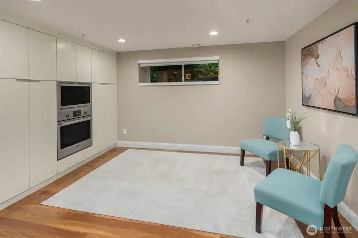 Just off the kitchen, this generous secondary space offers a natural gathering spot for the everyday moments — morning routines, casual evenings, a quiet corner while dinner is in the oven. Built-in wall oven and microwave keep everything within reach, while the open feel keeps the connection to the heart of the home.