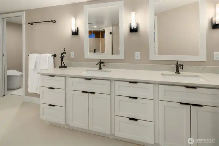Every detail of the primary bath speaks to a standard of living that is quietly exceptional — a sprawling dual vanity with marble countertop, abundant drawer storage, oil-rubbed bronze faucets, and a private water closet with Toto toilet. The kind of bathroom that makes getting ready feel less like a routine and more like a ritual.
