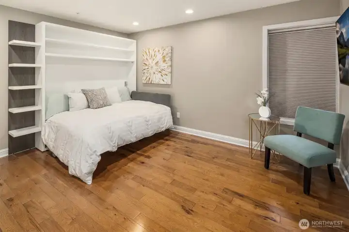 ersatility without compromise — the third bedroom features a custom Murphy bed with built-in shelving, an en-suite bath, and beautiful hardwood floors throughout. Guests get a private, comfortable retreat; when they leave, the room transforms into whatever you need it to be.