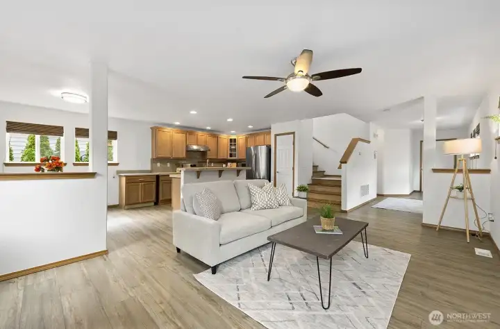 View from living room to kitchen and staircase.