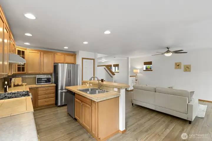 Kitchen with stainless steel appliances and new hood.