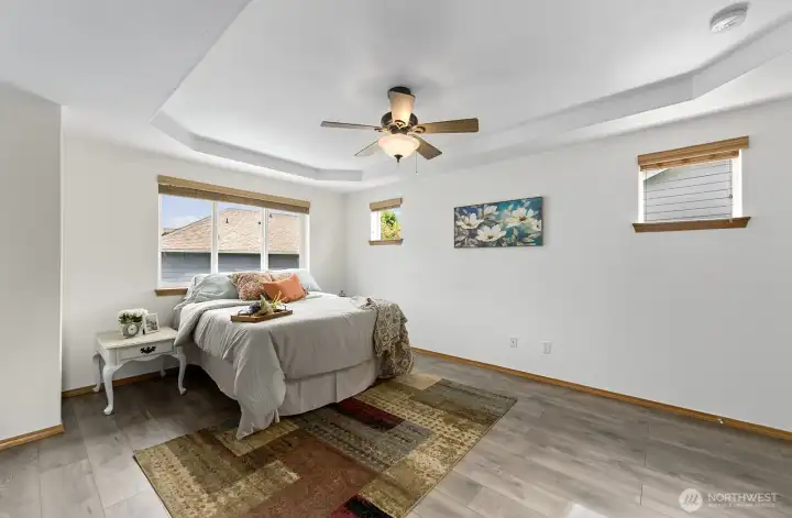 Primary suite features a recessed ceiling with fan.
