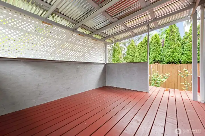 Back yard features covered deck, garden with fruit trees, shed, and greenhouse.