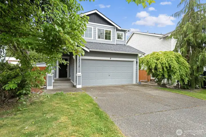 Two-car garage with ample driveway space for additional parking.